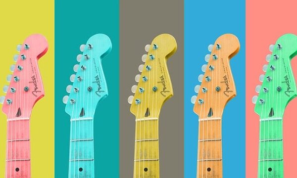 A display of the top halves of a handful of colorful guitars