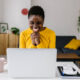 an excited Entrepreneur reaching her goals at her workstation